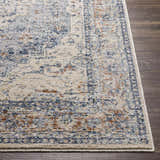 Close up of the Salmo Area Rug showing its traditional cream, navy, and brick red pattern. Front