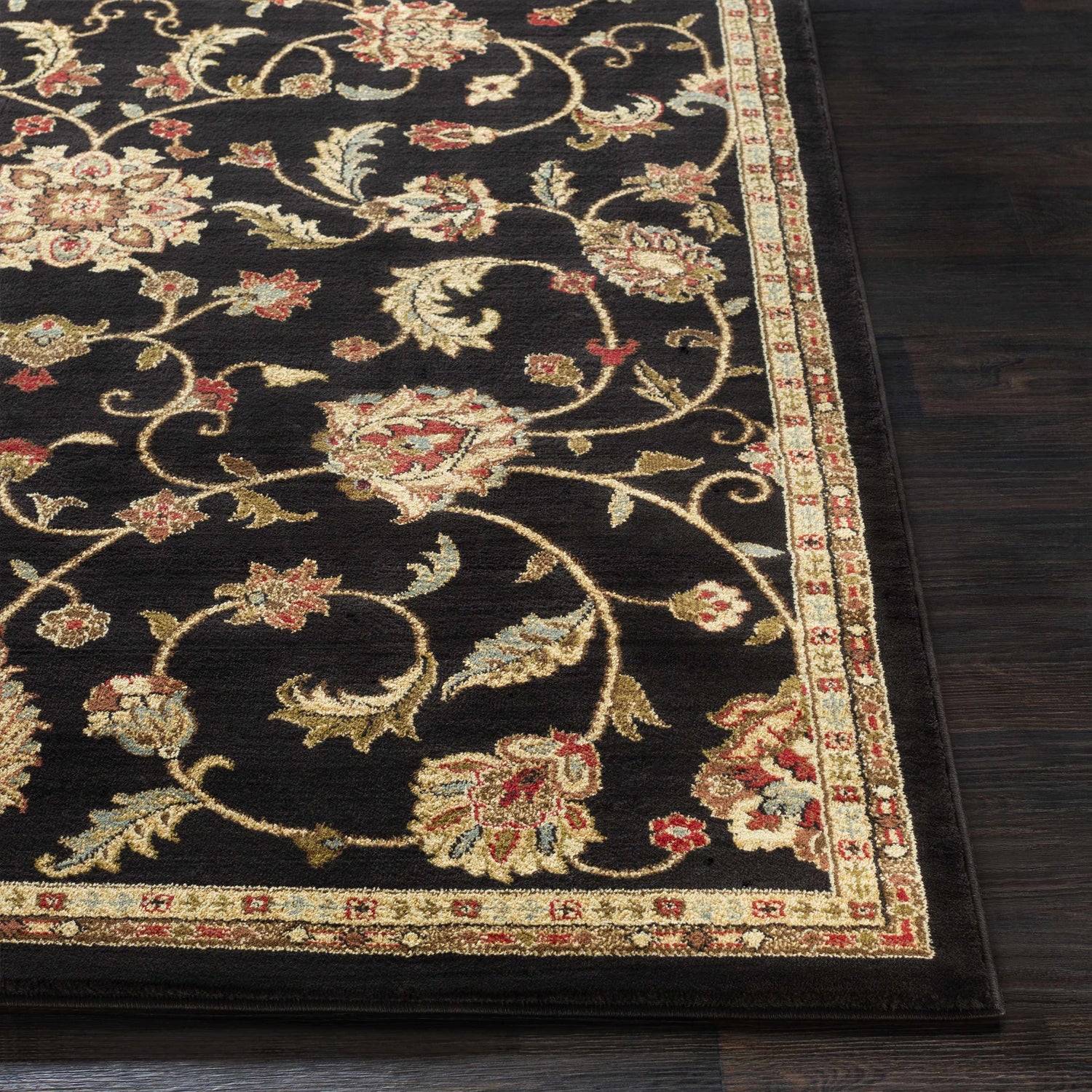 Close-up of the Salona Luxe Black Rug, a machine-woven rug with a black background and floral pattern in coral, beige, and brown. Front