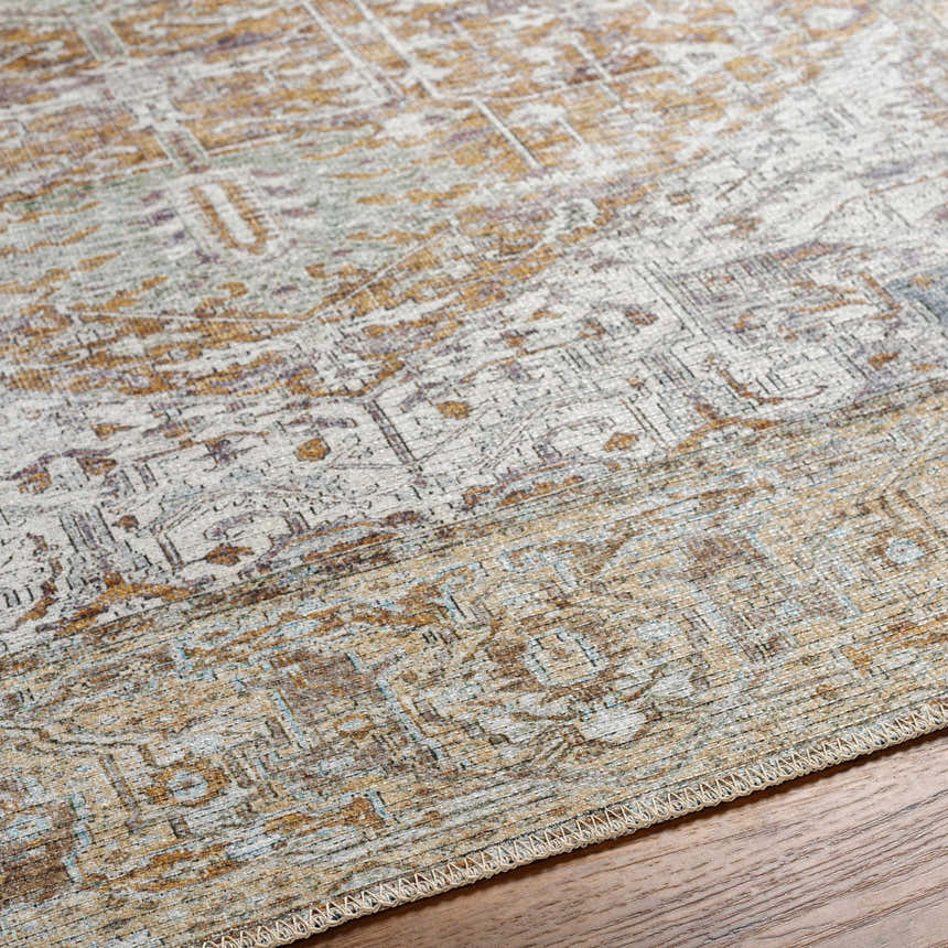 Close-up of Amato Mustard Washable Area Rug showing traditional farmhouse pattern, mustard, gold, and gray tones, and woven texture. Texture