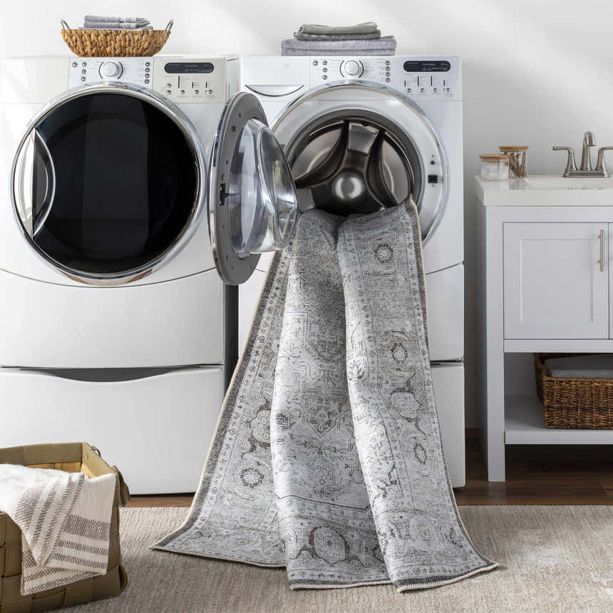 Anzu Washable Rug in laundry room with washer, dryer, and sink. Gray traditional rug is easy to clean. Washing-Machine