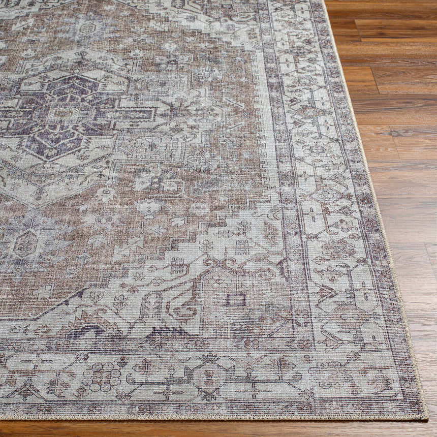 Close-up of Athor Washable Rug. Traditional style rug in dark gray, eggplant, multi brown, and natural gray colors. Front