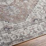 Close-up of the Athor Washable Rug showing its traditional brown, taupe, and gray pattern and machine woven texture. Texture