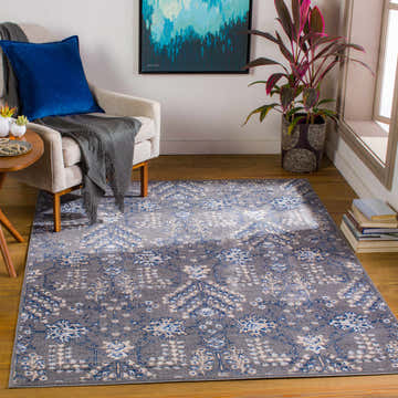 Living room scene with a Sapinero Gray Floral Rug, beige chair, blue pillow, and gray throw. Contemporary, traditional style. Roomscene-Rectangle