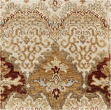 Close-up of the Saratoga Area Carpet. Hand-knotted wool rug with traditional brick red, camel, and taupe floral pattern. Texture