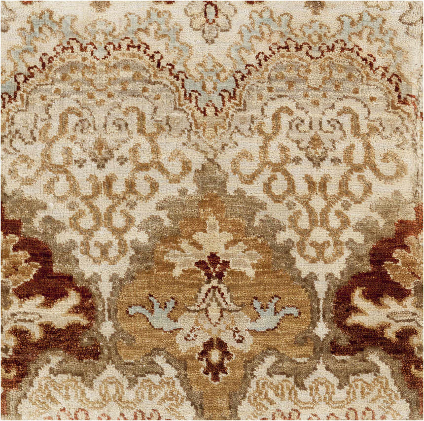 Close-up of the Saratoga Area Carpet. Hand-knotted wool rug with traditional brick red, camel, and taupe floral pattern. Texture