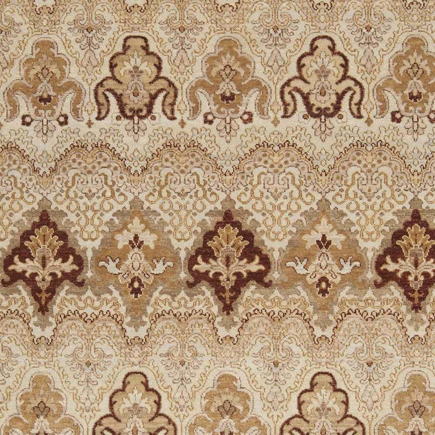 Close-up of the Saratoga Area Carpet showing its traditional, hand-knotted design in brick red, camel, and light brown wool. Swatch