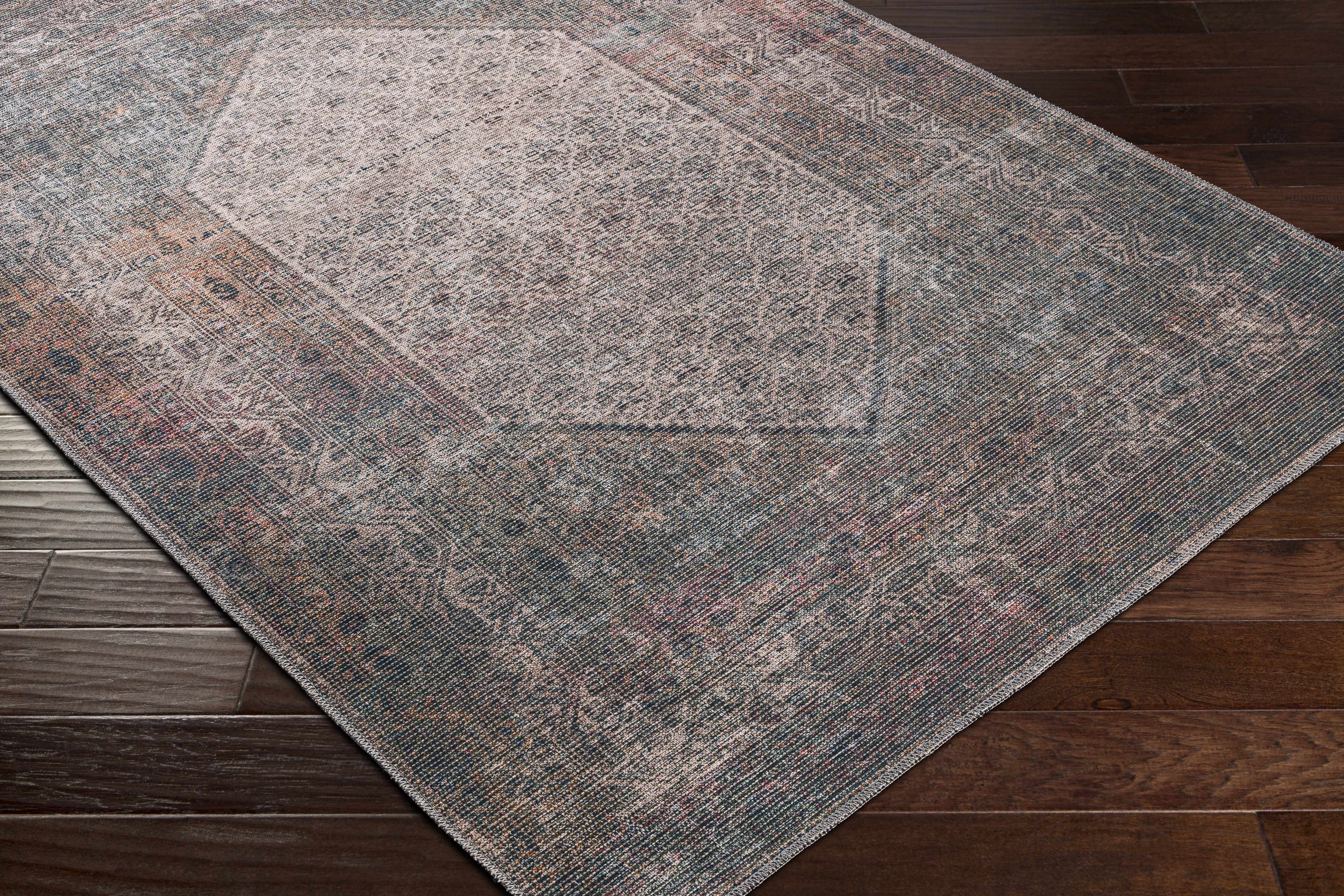 Zoomed-in view of the edge of Olive Sariaya Distressed Washable Area Rug - Clearance, focusing on border details and craftsmanship. Traditional Area Rug Backing Canvas 