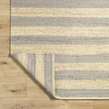 Close-up of the hand woven Ilkay Jute Area Rug. Camel and natural jute stripes add farmhouse style and texture. Fold