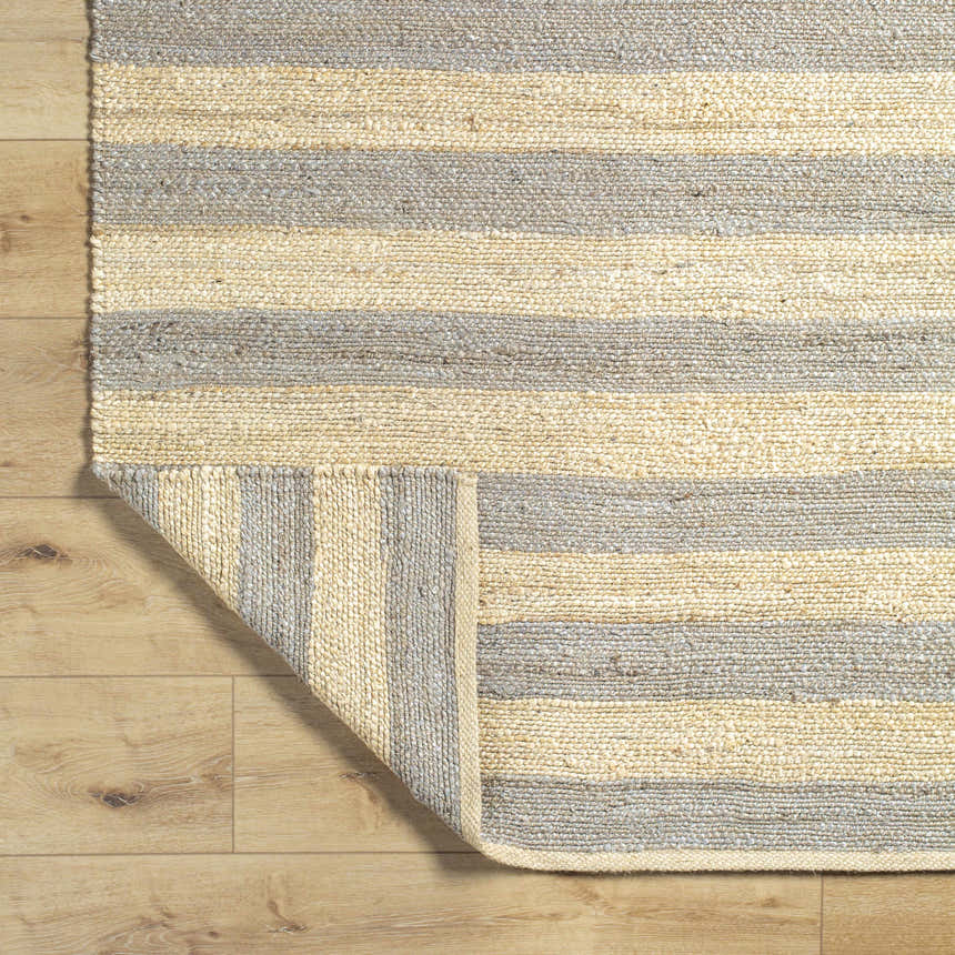 Close-up of the hand woven Ilkay Jute Area Rug. Camel and natural jute stripes add farmhouse style and texture. Fold