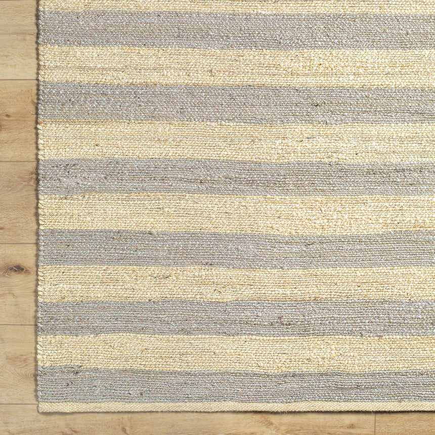 Close-up of the hand woven Ilkay Jute Area Rug. Camel and natural jute stripes add texture to floors. Farmhouse style. Corner