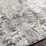 Close-up of the Satsop Rock Pattern Thick Rug. Abstract design in black, charcoal, gray, ivory, and tan. Soft texture. Texture