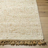 Close-up of the hand woven Gopi Jute&Wool Area Rug in Cream, showing texture and jute fringe detail. Front