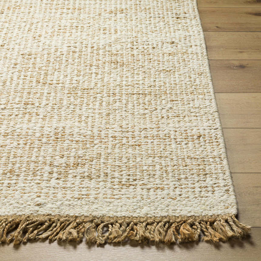 Close-up of the hand woven Gopi Jute&Wool Area Rug in Cream, showing texture and jute fringe detail. Front
