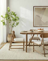 Dining room with a light wood table and chairs on a cream Gopi Jute&Wool Area Rug. Farmhouse style. Roomscene-Rectangle