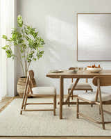 Dining room with a light wood table and the Gopi Jute&Wool Area Rug in Cream, creating a warm, neutral, Scandinavian style. Roomscene-Rectangle