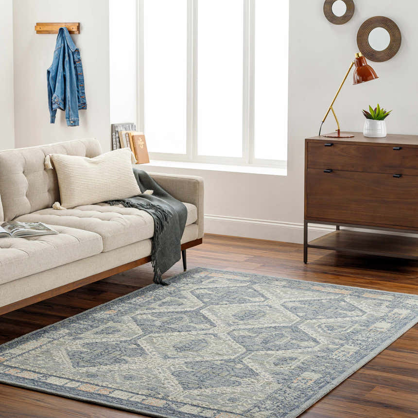 Living room with a gray Doman Area Rug, light beige sofa, and mid-century modern wood dresser. Roomscene-Rectangle