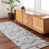 Entryway with light wood console table, plant, and blue Denna Area Rug runner with Southwestern pattern. Roomscene-Runner