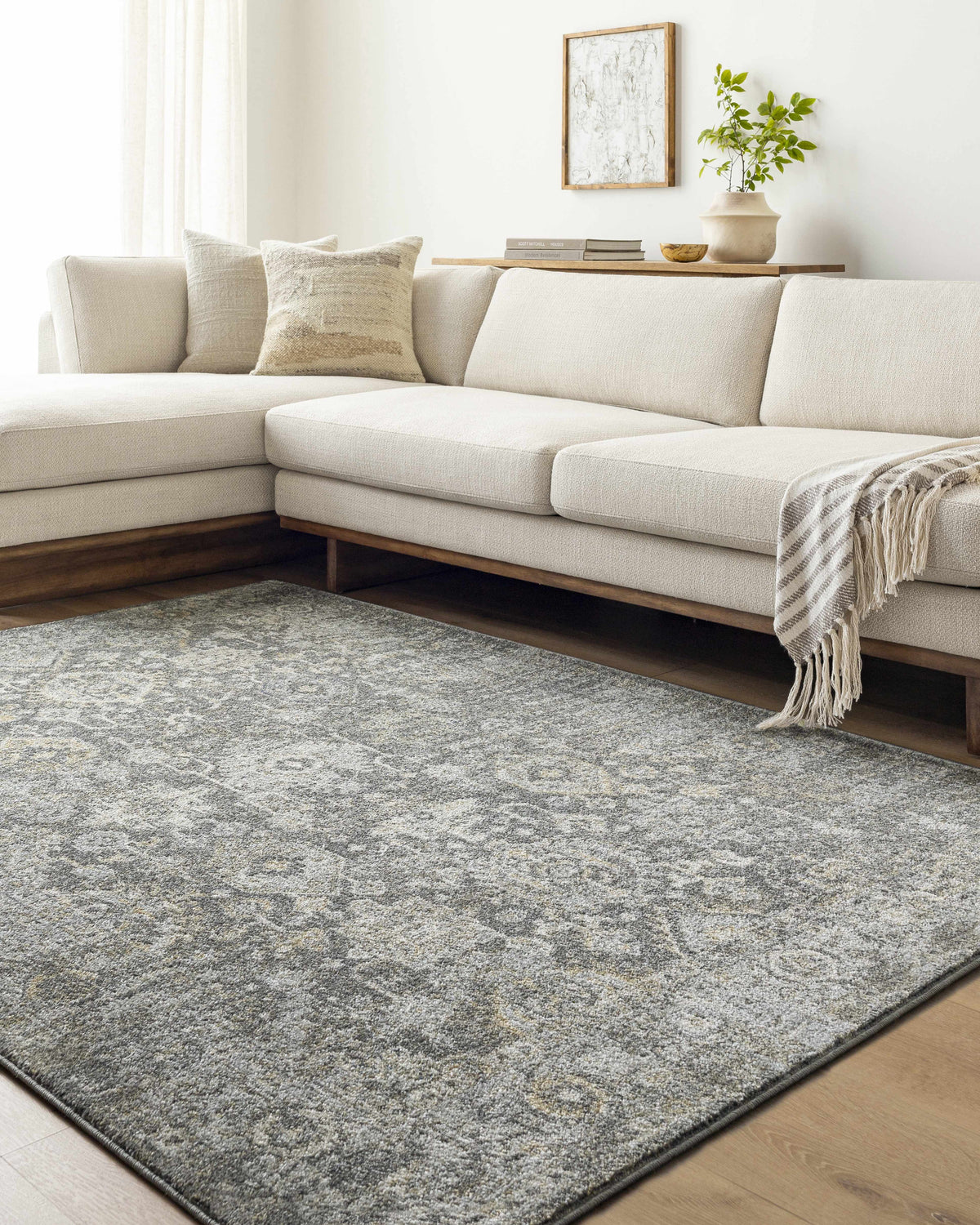 Living room scene with cream sectional sofa and gray Strom Area Rug. Roomscene-Rectangle