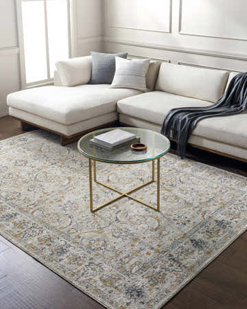 Living room with a Jeven Gray Area Rug, white sectional sofa, and gold-legged glass coffee table. Roomscene-Rectangle