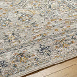 Close-up of the Jeven Gray Area Rug showing its farmhouse style, light gray, natural gray, and yellow tones. Texture