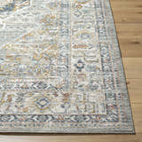 Close-up of Jyler Traditional Area Rug in beachhouse beige. Machine-woven polyester rug with farmhouse style pattern. Front