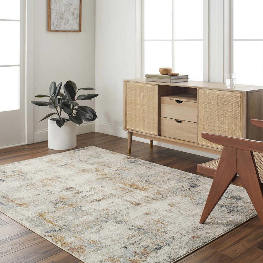 Living room scene with beige Kacia Area Rug, wood console table, and modern chair on dark wood floors. Roomscene-Rectangle