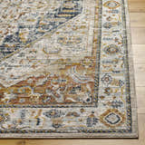 Close-up of the Kuruk Area Rug showing its traditional light gray, natural gray, and gold pattern and soft texture. Front