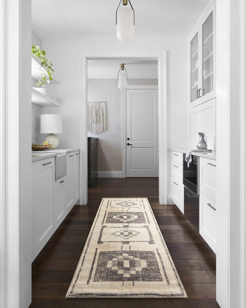 Farmhouse kitchen hallway with Solana Medallion Charcoal runner rug, white cabinets, and dark wood floors. Roomscene-Runner
