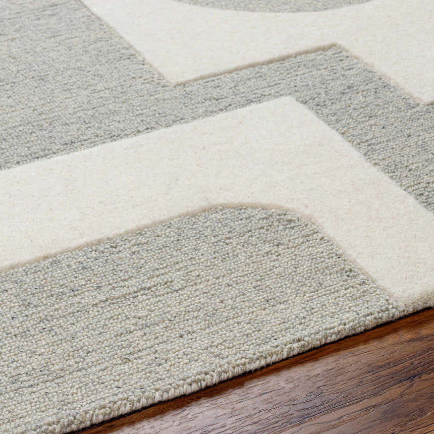 Close-up of the hand-tufted Adeja Area Rug. Gray wool rug with a geometric pattern in light gray. Contemporary style. Texture