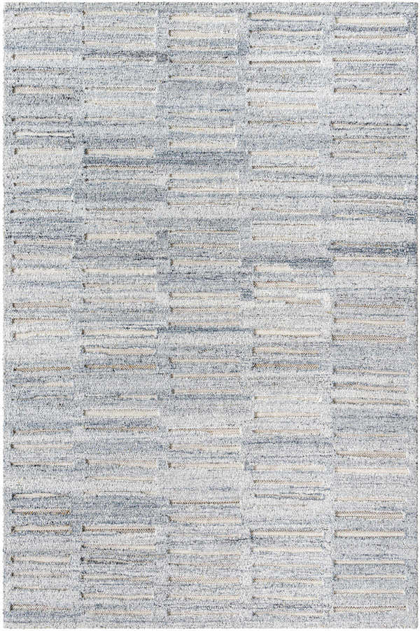 Close-up of the hand-tufted Darcy Area Rug. Features a geometric pattern in shades of blue, gray, and cream. Design-Rectangle-576