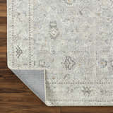 Close-up of Davina Damask Sage rug showing beige, gray, and brown tones. Farmhouse style polyester rug with damask pattern. Fold