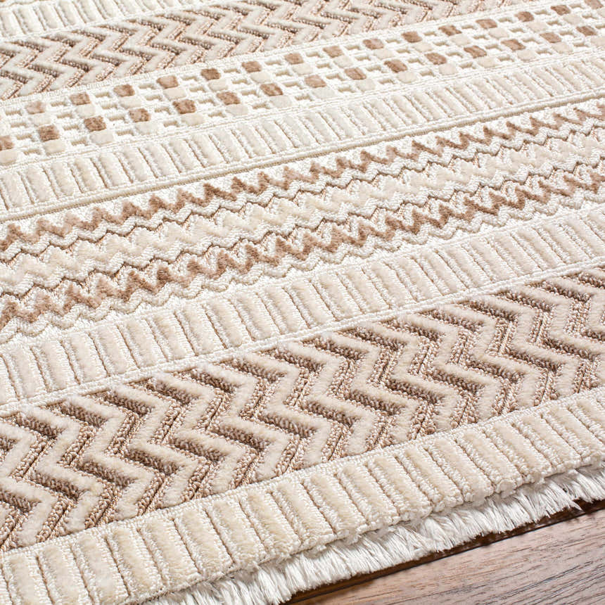 Close-up of the Eiko Beige Textured Saxony Rug with Fringes, showcasing its geometric pattern and soft, neutral tones. Texture