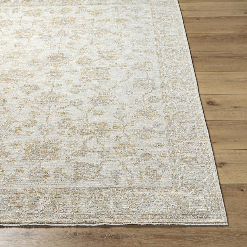 Close up of the Sashi Tan Luxe Area Rug showing its traditional floral pattern and tan, ash, and light silver colors. Front