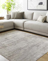 Living room scene with a gray sectional sofa and the Odeya Area Rug in cloud gray and medium gray. Roomscene-Rectangle
