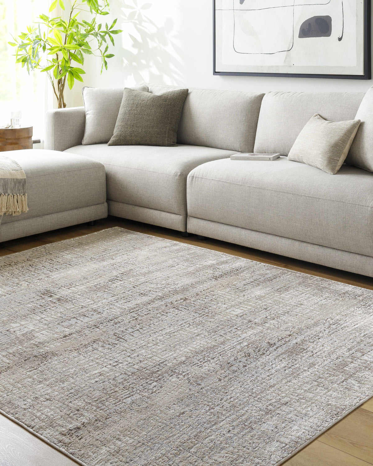 Living room scene with a gray sectional sofa and the Odeya Area Rug in cloud gray and medium gray. Roomscene-Rectangle