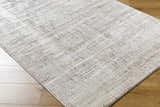 Close-up of the Odeya Area Rug. Cloud gray and medium gray Southwestern design with a subtle geometric pattern. Corner