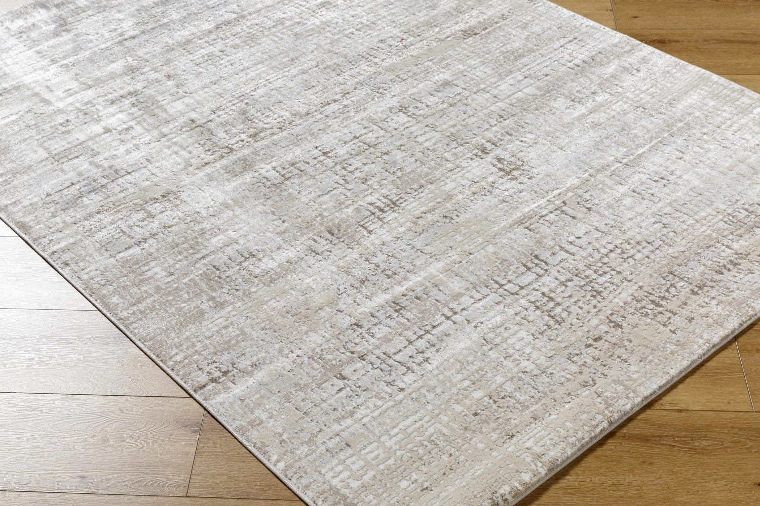 Close-up of the Odeya Area Rug. Cloud gray and medium gray Southwestern design with a subtle geometric pattern. Corner