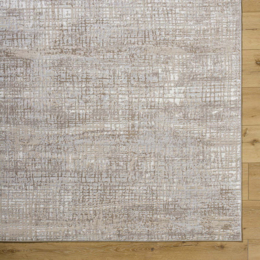 Close-up of the Odeya Area Rug. Cloud gray and medium gray Southwestern design with a subtle grid pattern. Corner