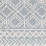 Close-up of the Scawby Area Rug. Light blue rug with a geometric diamond and border pattern. Woven texture. Swatch