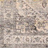Close-up of the Ailsa Area Rug, showcasing its farmhouse-style pattern in dark gray, lambswool, and taupe hues. Swatch