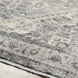 Close-up of the Ailsa Area Rug, showcasing its dark gray, lambswool, and taupe traditional pattern and soft texture. Texture