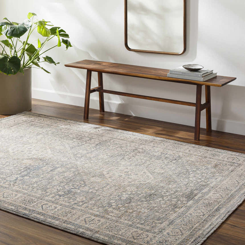 Entryway with Artan Area Rug in gray, wood bench, mirror, and potted plant. Roomscene-Rectangle