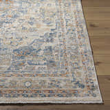 Close-up of the Bora Area Rug. Farmhouse style rug with camel, copper, and blue traditional pattern. Front