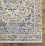 Close-up of the Bora Area Rug in camel, copper, and blue tones, showcasing its traditional pattern and soft texture. Corner