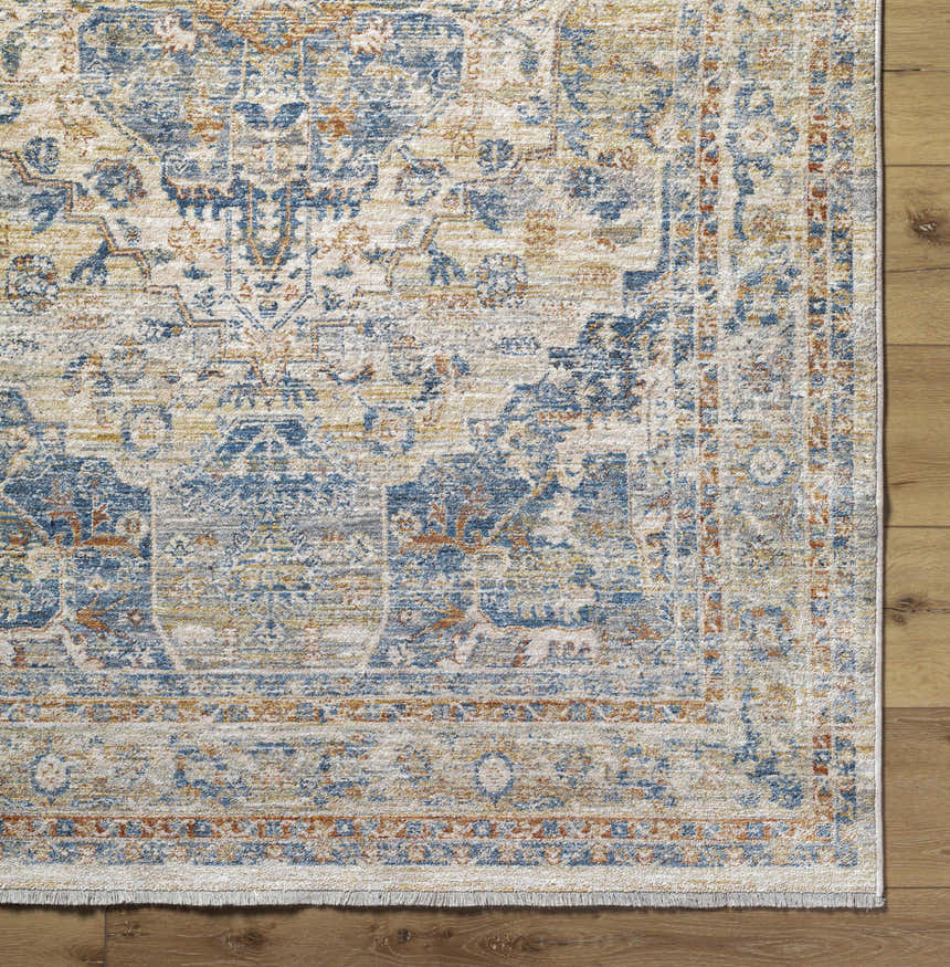 Close-up of the Bora Area Rug in camel, copper, and blue tones, showcasing its traditional pattern and soft texture. Corner