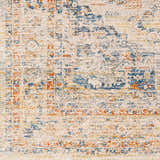 Close-up of the Bora Area Rug: a traditional, machine-woven design in camel, copper, and blue tones. Swatch