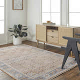 Living room scene with a clay, copper, and denim Dalit Area Rug, light wood cabinet, and modern black chair. Roomscene-Rectangle