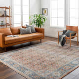 Living room scene with a clay and denim Dalit Area Rug, leather sofa, and wood accents. Roomscene-Rectangle