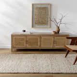 Living room scene with a beige Mitzy Area Rug, wood console table, and woven chair. Roomscene-Rectangle