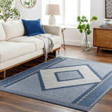 Living room scene with a blue and gray Onan Area Rug, white sofa, and wood accents. Roomscene-Rectangle